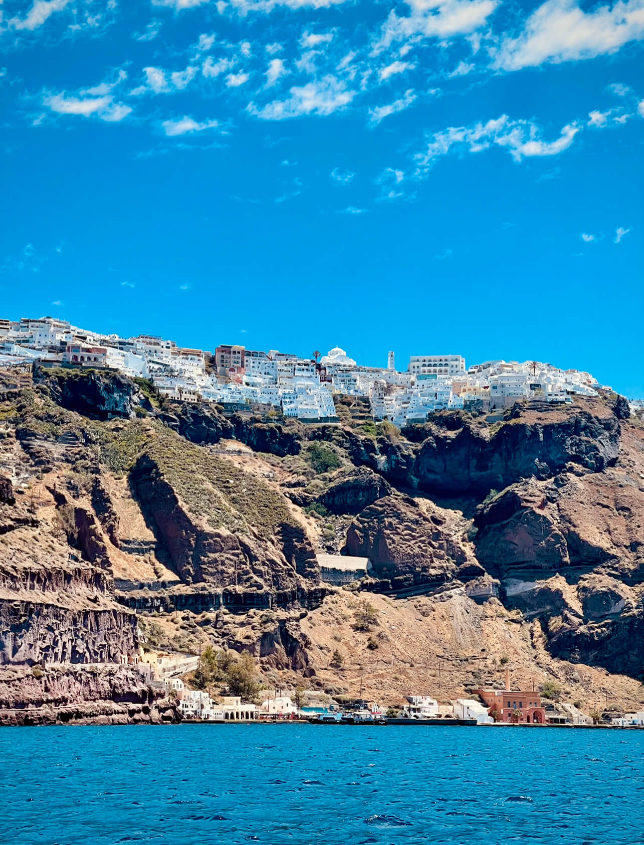 Fira Port is where the cruise ship tenders berth with Thira above.